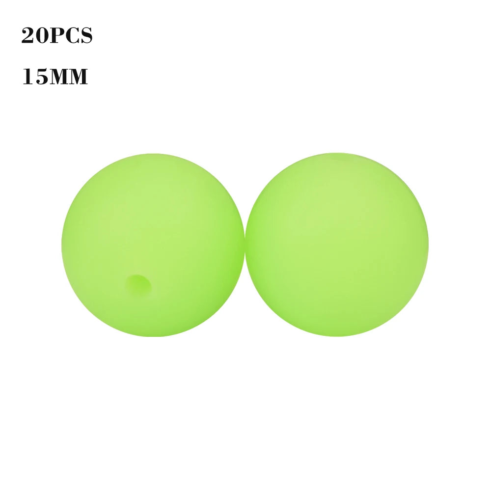A pair of bright lime green silicone beads, 15mm in size, for jewelry making.