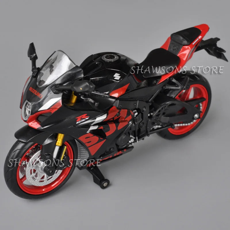 A black and red Suzuki GSX-R1000R diecast motorcycle model in a dynamic pose.