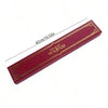 A long, rectangular red magic wand with gold detailing, shown diagonally.