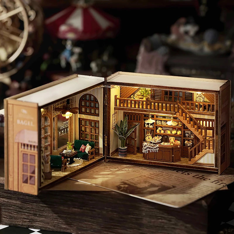 A wooden miniature dollhouse kit featuring detailed furniture and lighting elements displayed in an open box.