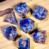 A collection of handcrafted resin polyhedral dice in light purple with gold numbers scattered on lined paper.