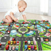 A baby is interacting with a colorful Kids City Road Map Play Mat featuring various vehicles and city scenes.