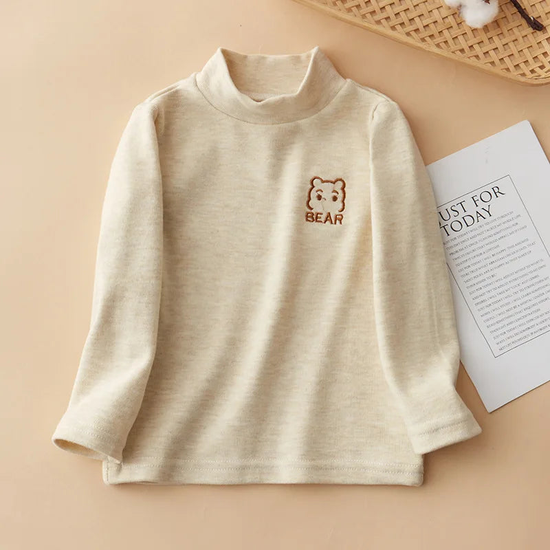 A beige kids long sleeve t-shirt with a small brown bear embroidery on the chest.