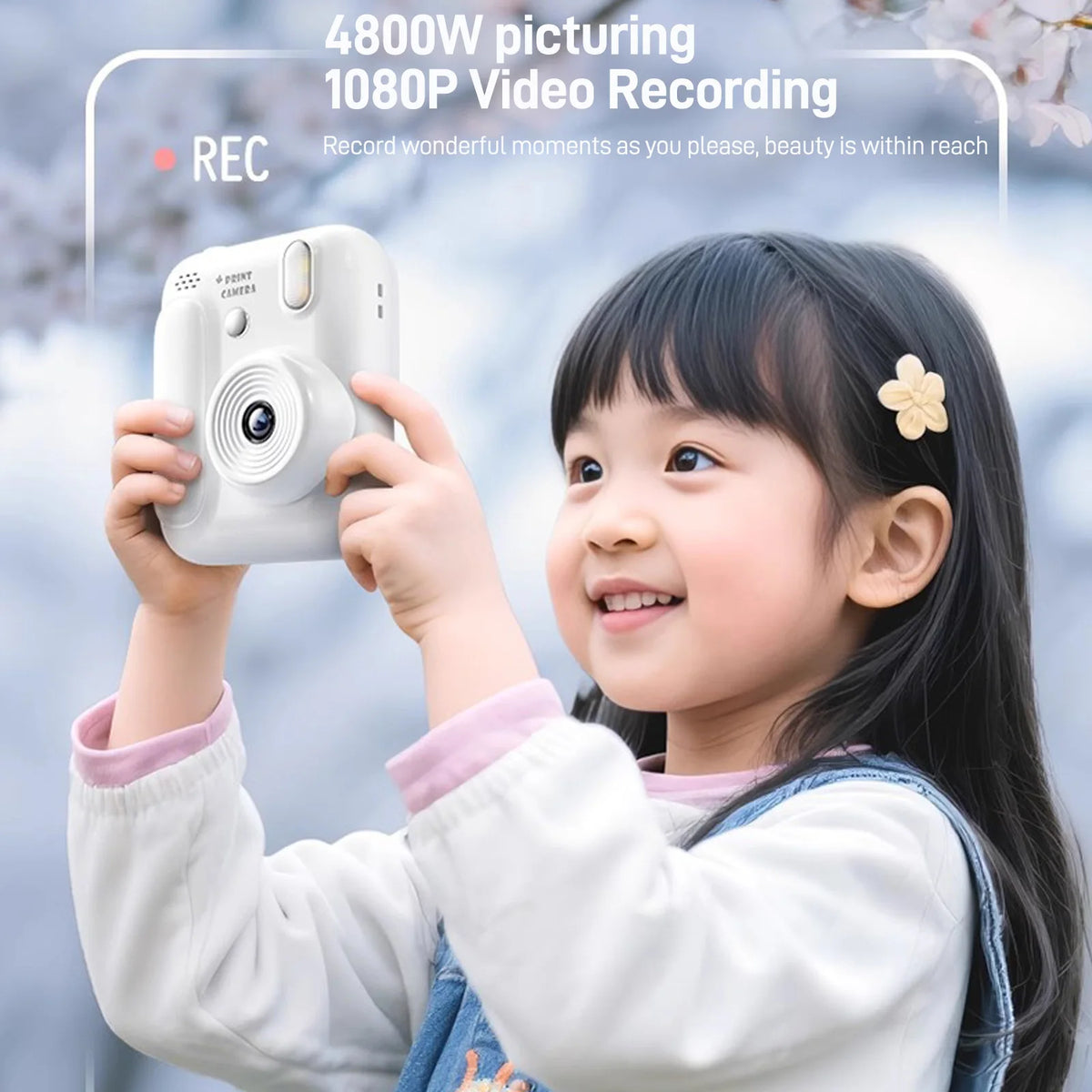 A young girl is holding a white instant camera for video recording outdoors.