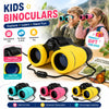 A set of yellow kids binoculars with black straps and lenses shown in an outdoor context.