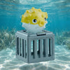 A yellow and white sea lion toy is visible inside a gray plastic cage submerged underwater.