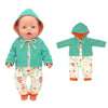 A baby doll wearing a teal hooded outfit and matching patterned pants.
