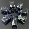 A set of seven floral resin potion bottles shaped like polyhedral dice, featuring various numbers and flowers.