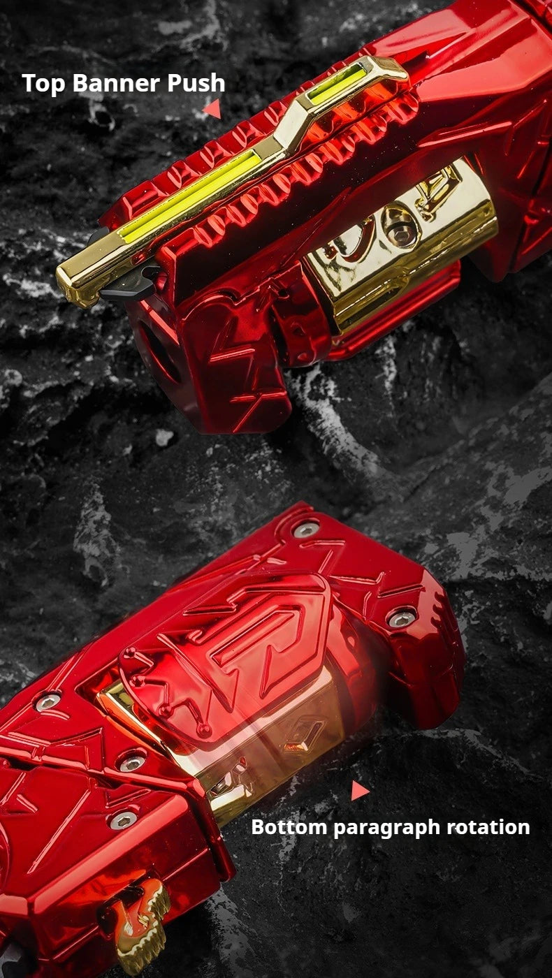 Close-up view of a red metal gun-shaped fidget slider with gold accents, showing top banner push and bottom paragraph rotatio
