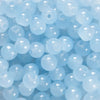 A close-up view of small, round, light blue glass beads for DIY jewelry making.