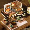 A wooden miniature dollhouse assembly kit featuring detailed furniture and architectural elements.