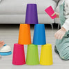 A set of colorful plastic stacking cups in various shades of purple, orange, blue, pink, and green are arranged on a floor.