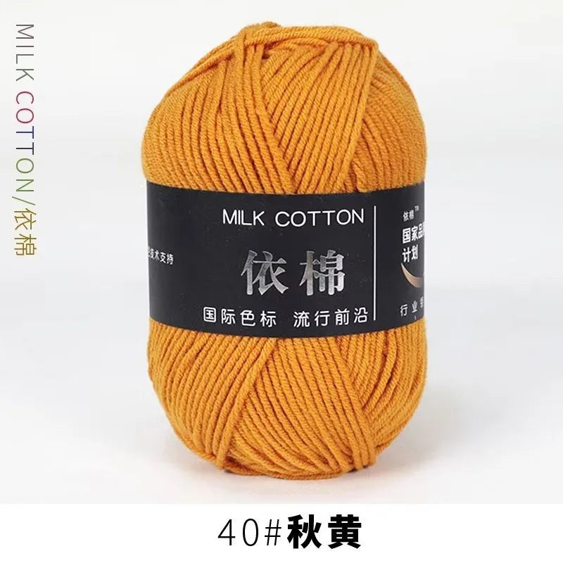 A ball of orange milk cotton yarn labeled with Chinese characters and the designation 40# Autumn Yellow.