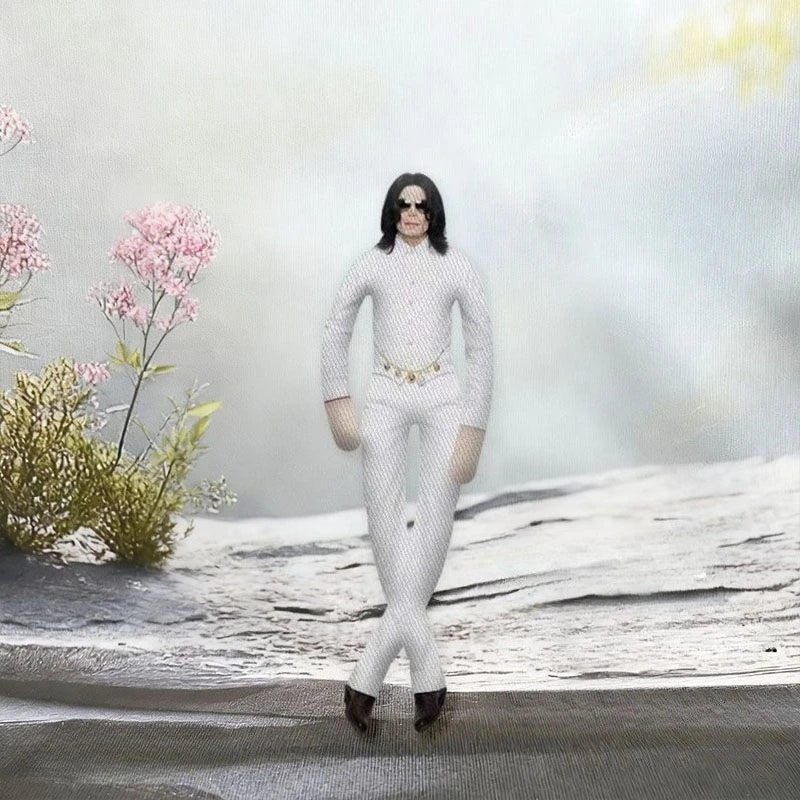 A plush doll resembling Michael Jackson with long black hair and white outfit standing in a snowy outdoor setting.