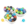 A collection of colorful rhinestone resin bayberry ball beads in various shades and sizes displayed in white bowls.
