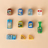 A collection of colorful mini building blocks shaped like food items including soup, pasta, wheat flour, and olives.