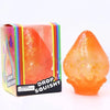 A squishy toy shaped like a raindrop in orange and yellow colors, packaged in a box.