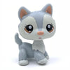 A small, stylized figurine of a white and gray deer-like animal with large brown eyes.