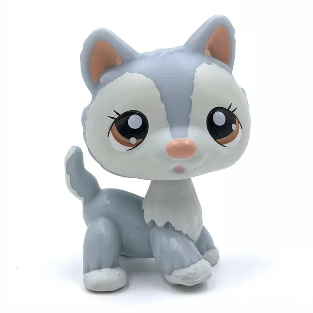 A small, stylized figurine of a white and gray deer-like animal with large brown eyes.