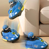 A blue remote control battle car toy for kids is shown in various poses on a light-colored sofa and wooden floor.