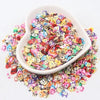 A white dish filled with colorful polymer clay sprinkles for slime and craft decor
