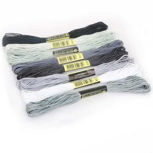 A set of multicolor embroidery floss skeins with a glitter finish, bundled together.