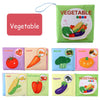 A set of soft fabric baby books featuring various vegetables like tomatoes, carrots, broccoli, pumpkin, corn, bell peppers, a