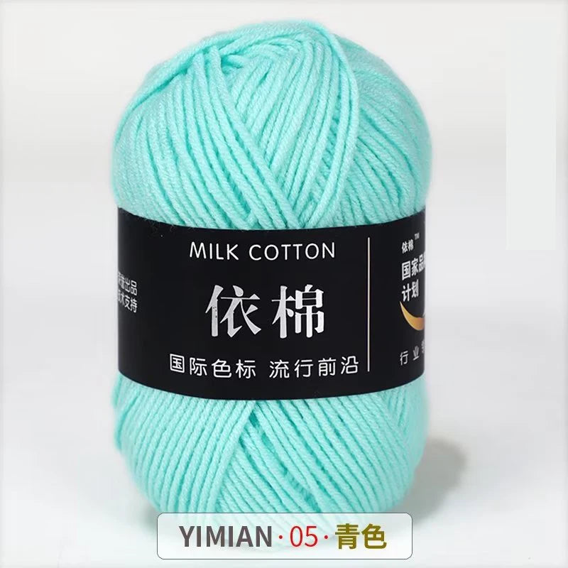 A ball of light mint green milk cotton yarn labeled with Chinese characters and a YIMIAN code.