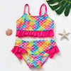 A vibrant two-piece girls' swimsuit set featuring a colorful rainbow scale pattern in pink, blue, and green.