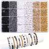 A variety of black, white, and gold beads and alphabet beads are displayed in a compartmentalized kit for DIY jewelry making.