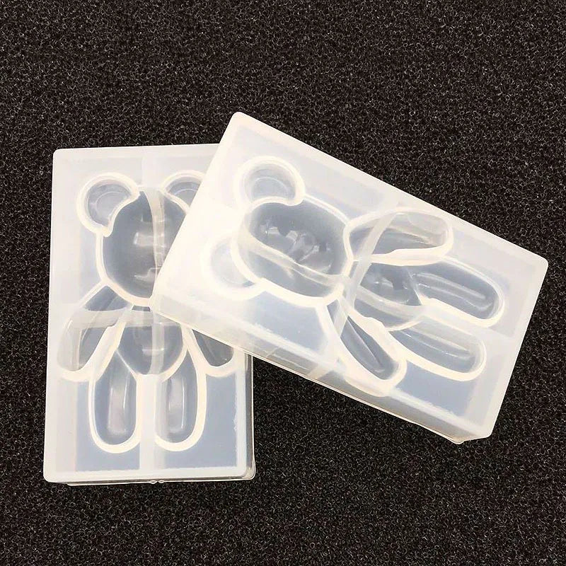A clear silicone mold with bear-shaped cavities for resin jewelry and crafts