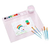 A pink painting mat set featuring a watercolor palette, various paint colors, and brushes for kids.
