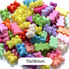 A pile of pastel bear-shaped acrylic craft beads in various colors like pink, yellow, green, and purple.