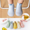 A collection of adorable animal soft sole socks for babies and toddlers in various pastel colors.