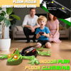 A child plays with a green lizard robot toy on the floor in an indoor game setting.