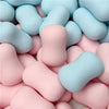 A pile of squishy fidget blocks in pastel blue and pink colors.