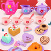A colorful 27-piece pretend play tea party set featuring pink and purple ceramic teapots, cups, and pastries on a red backgro