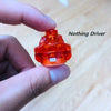 A hand holds an orange Nothing Driver component, a gyro driver for spinning tops.