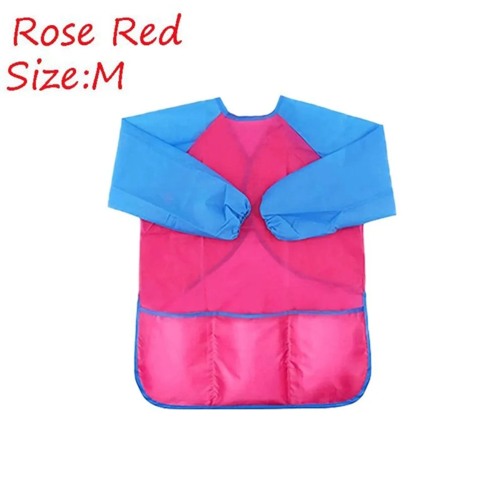 A pink and blue waterproof kids art and baking apron with long sleeves.