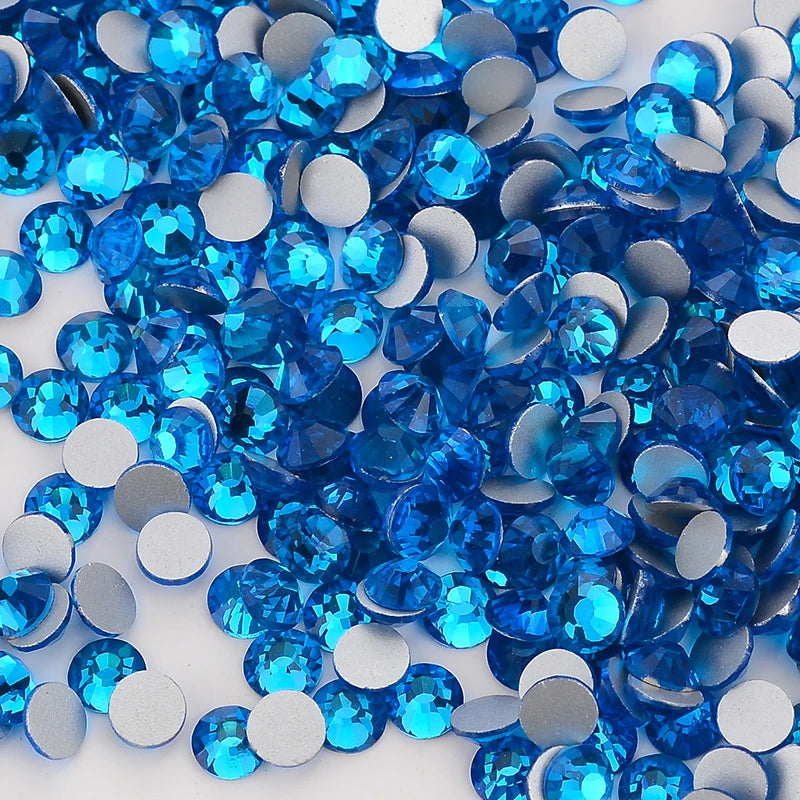 A pile of blue and silver glass crystal flatback rhinestones for nail art and crafts.
