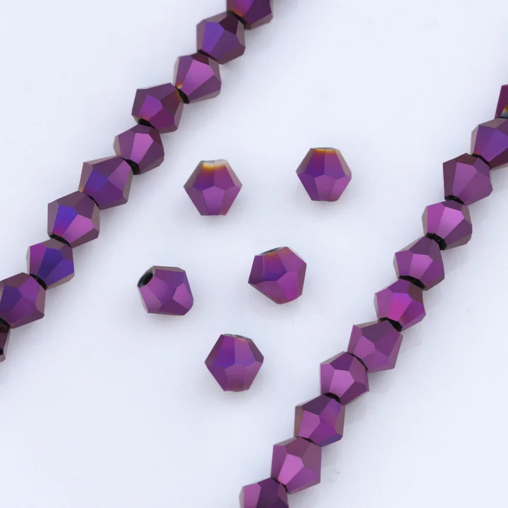 A collection of purple and violet faceted glass beads arranged in linear strands and scattered pieces for jewelry making
