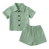 A baby boy cotton linen outfit set consisting of a short-sleeved shirt and matching shorts in a sage green color.