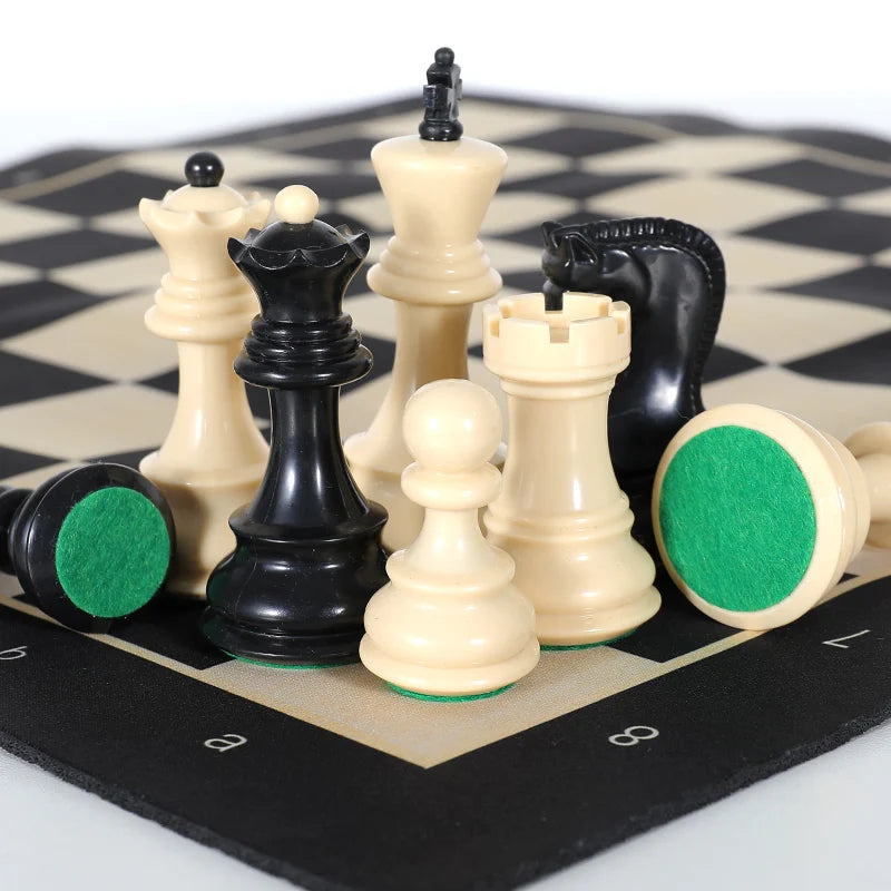 A portable folding chess set with weighted black and white pieces displayed on a checkered board.