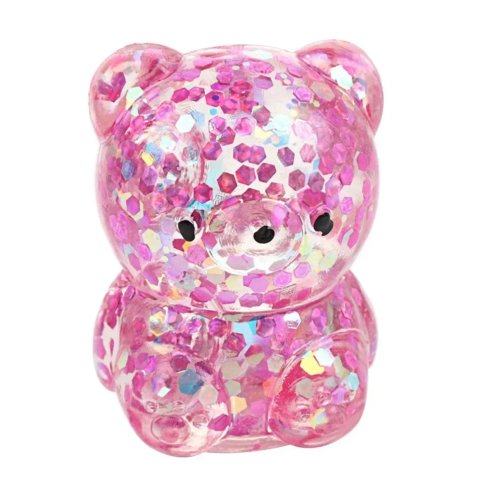 A pink tactile water bead stress ball shaped like a pig with glitter inclusions.