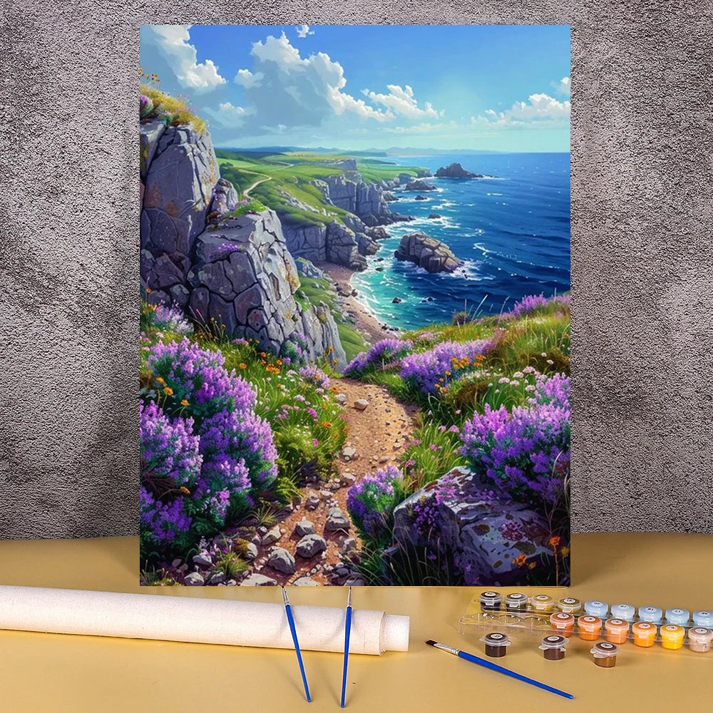 A painting in progress of a scenic coastal landscape featuring cliffs, purple flowers, and blue sea.