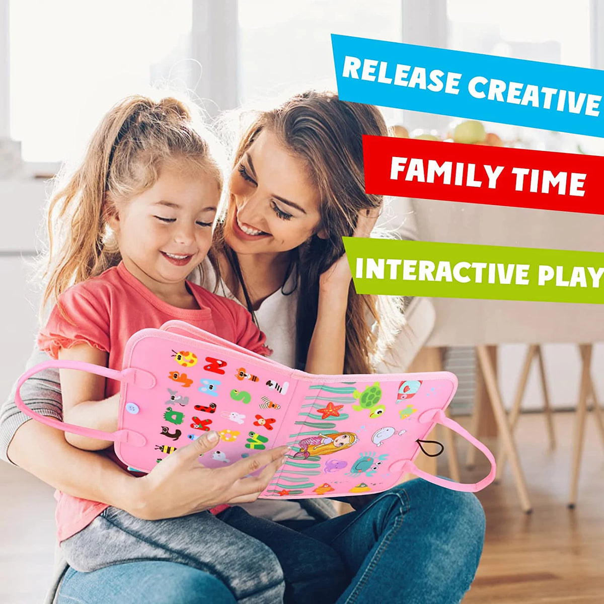 A young girl is playing with a pink Montessori busy board for toddlers while being supervised by an adult.