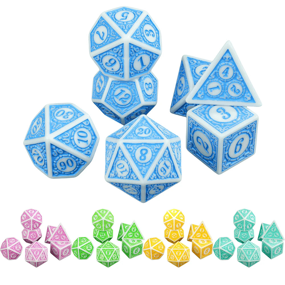 A collection of seven polyhedral dice in various shades of blue and green.