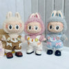 Three fluffy Labubu dolls wearing casual sneakers and outfits.