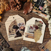 A flat lay of vintage PET sticker sheets, dried leaves, pinecones, and aged paper on a wooden surface.