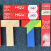 A wooden tangram puzzle featuring geometric shapes, including a large 'T' shape and various colored pieces.